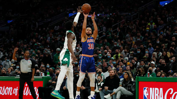 Dec 17, 2021; Boston, Massachusetts, USA; Golden State Warriors guard Stephen Curry (30) shots over Boston Celtics guard Jaylen Brown (7) during the first quarter at TD Garden.
